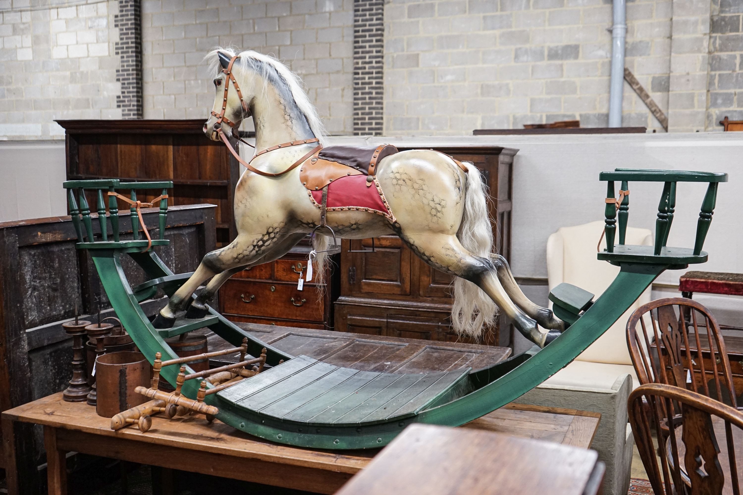 A large Victorian style painted rocking horse with end seats, length 240cm, height 132cm